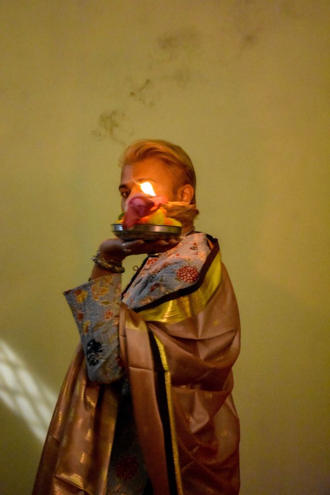 Man standing and holding a candle