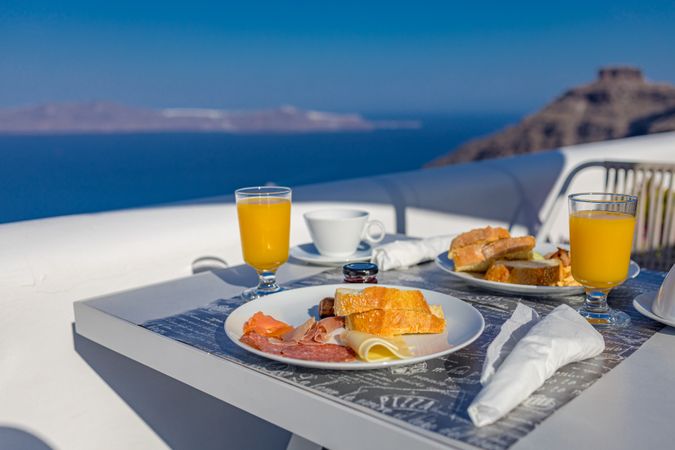 Toast, orange juice, meats and cheese breakfast outside in Greece