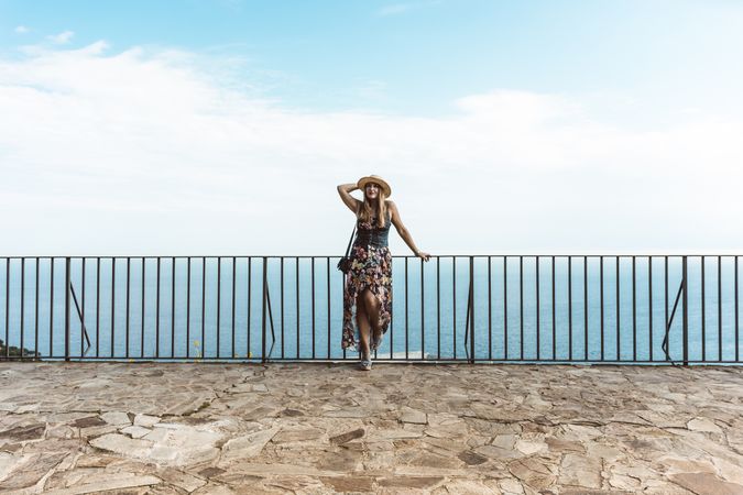 Stylish woman on terrace of seashore