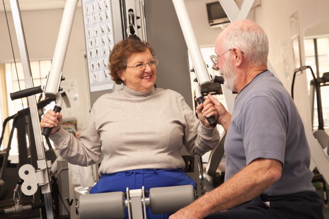 Mature Adult Couple Working Out Together in the Gym