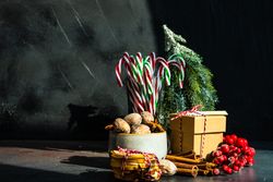 Christmassy scene with dried fruit, strings, cinnamon and holly with copy space