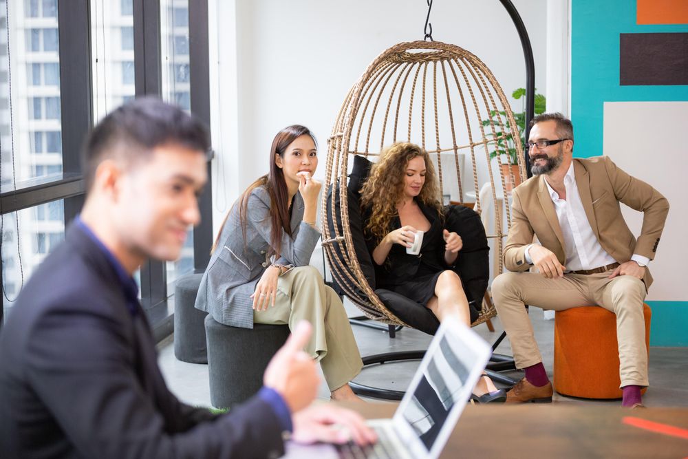 Group of businesspeople working in different parts of the office