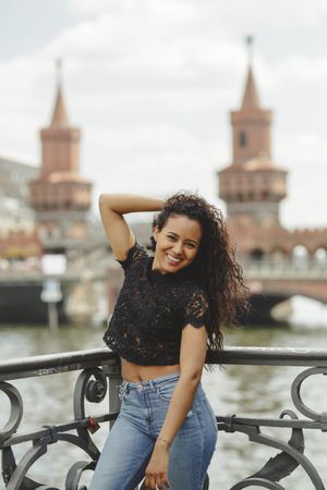 hispanic woman leaning on railing