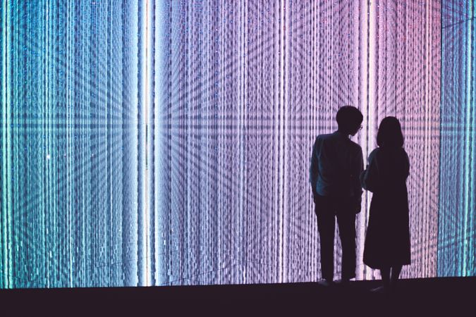 Tokyo, Japan - November 19th, 2019: Couple standing in front of colorful prismatic exhibition