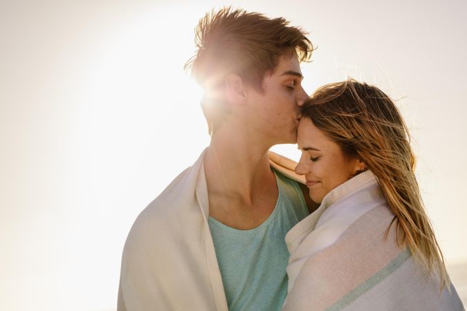 Man kissing his girlfriend on forehead