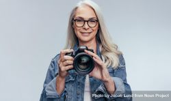 Professional female photographer with camera 5XwwP0