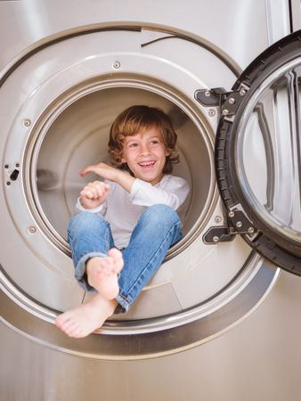 Cheerful boy in washing machine