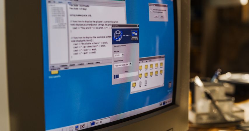 Close Up Shot Of Old Desktop Computer On Work Desk Of College Student In Nineties Retro Garage.