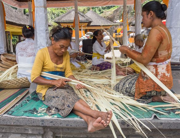 Sulawesi Island, Indonesia - August, 15 2015: Asian women working with dried leaves