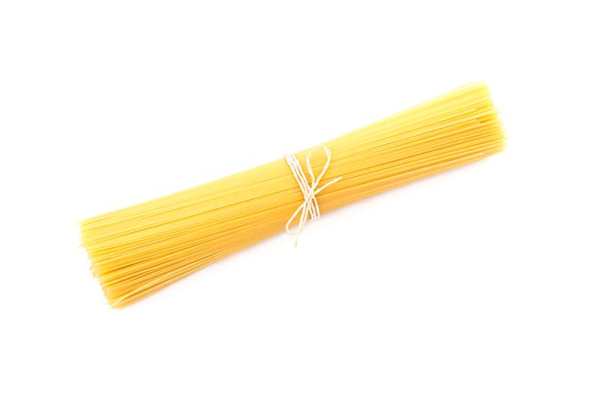 Pasta isolated on bright background. Uncooked whole wheat pasta