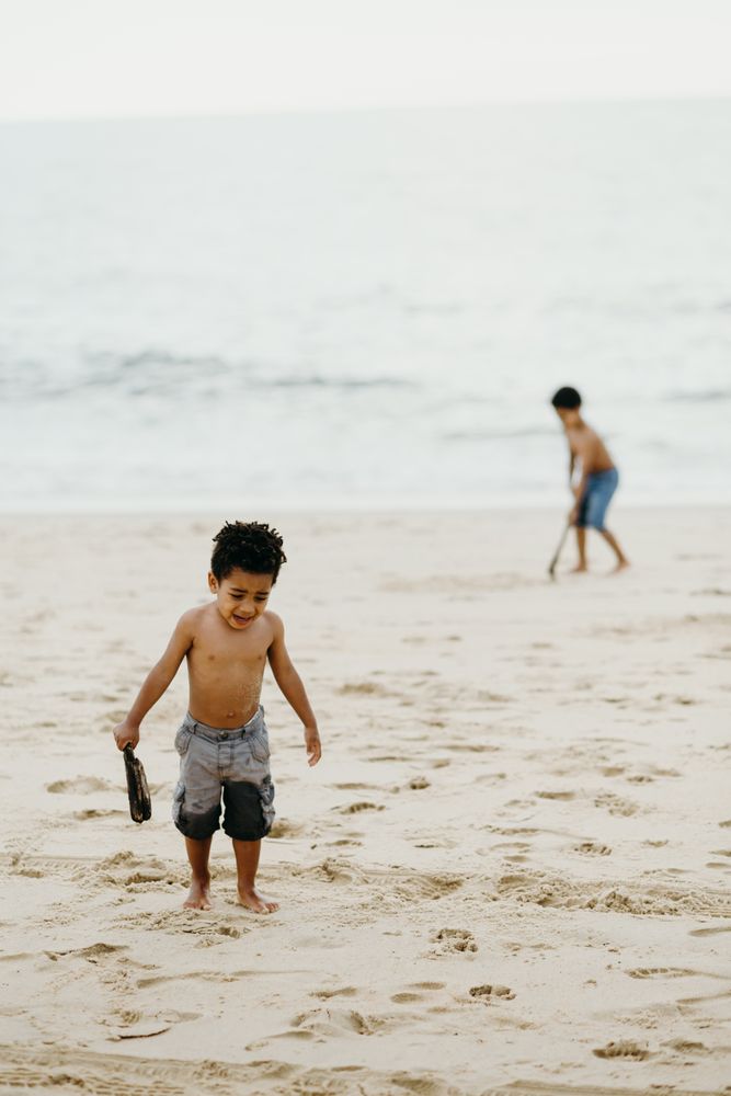 Black boy playing on beach