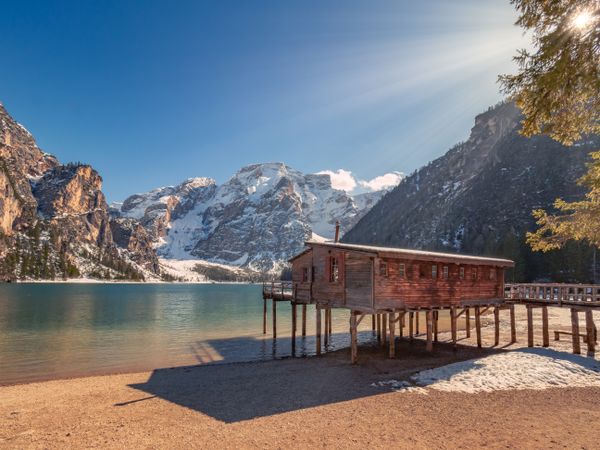 Wooden house on stilts on serene lake