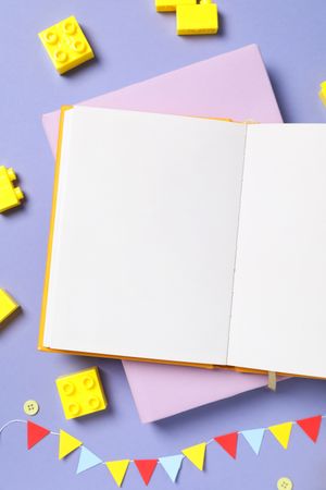 Children's book, with toys, on a purple background.