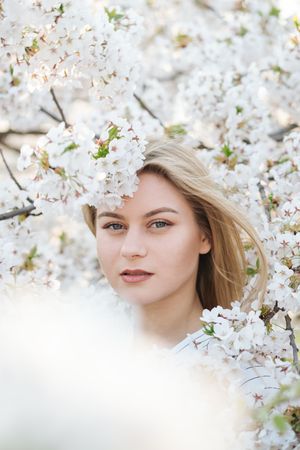 woman amidst white flowers