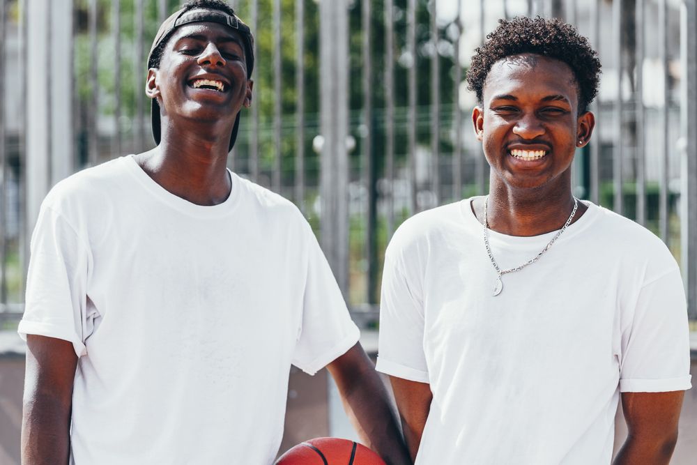 Black sportsmen with ball looking at camera