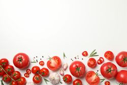 Composition with tomatoes and ingredients on light background, top view