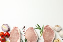 Composition with raw meat and ingredients on light background, top view