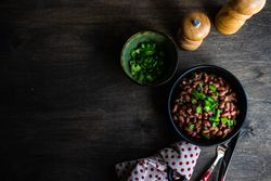 Traditional Georgian lobio dish in cast iron pan on spotted napkin