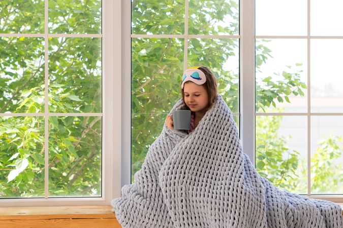 Young girl enjoying a hot drink