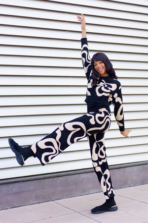 Dancer performing free style raising the leg in the street