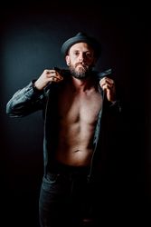 Young shirtless bearded guy in leather jacket