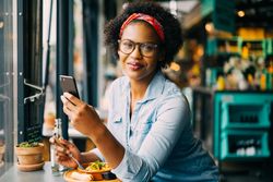 Woman with phone at a cafe