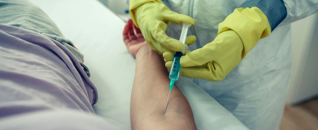 Doctor injecting a vaccine to a patient