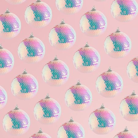 Sparkly disco Christmas bauble ornaments on a soft pink background