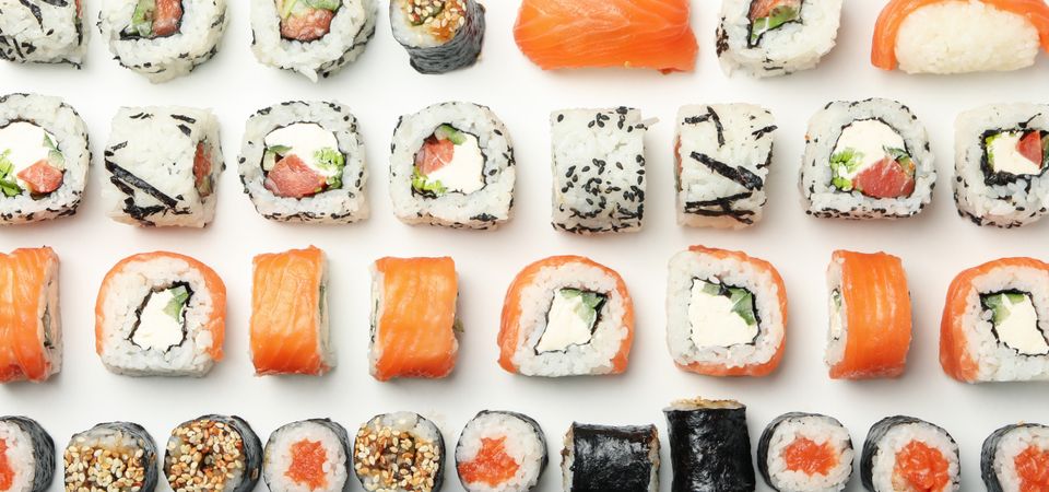 Flat lay with sushi rolls on light background. Japanese food
