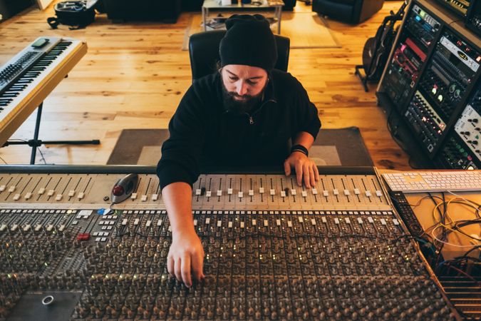 Man in a equalizer instrument in a studio
