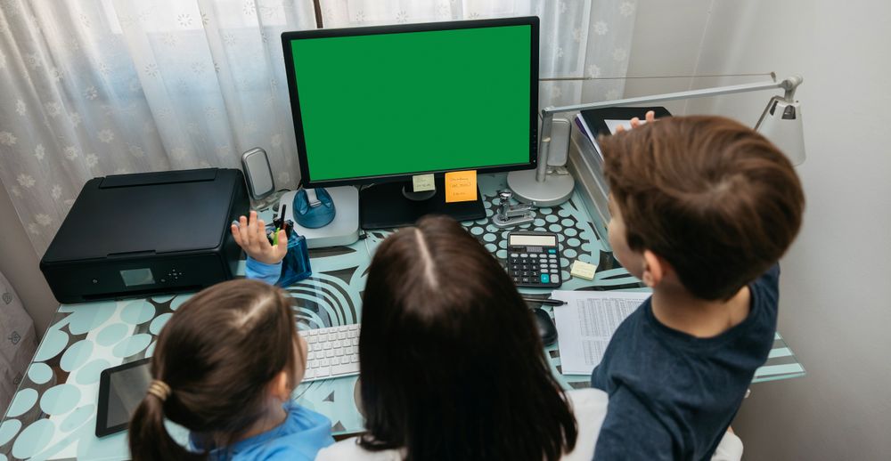 Mother and children looking at computer screen