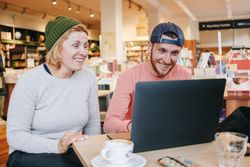 Two people working in cafe