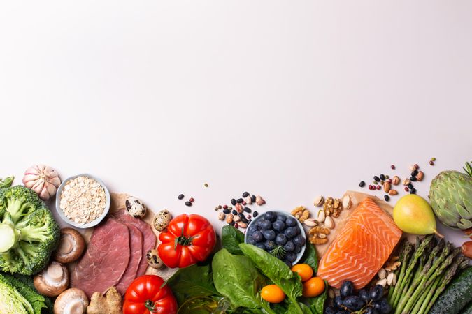 Assortment of healthy food ingredients for cooking lined up with copy space