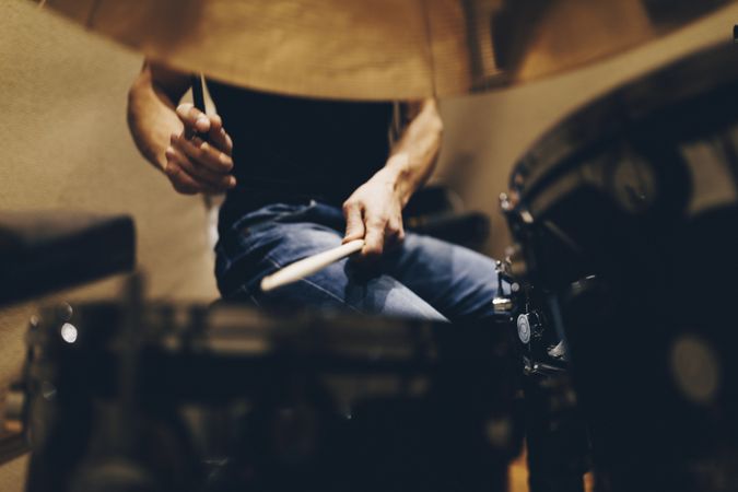 Man with headphones playing on drums