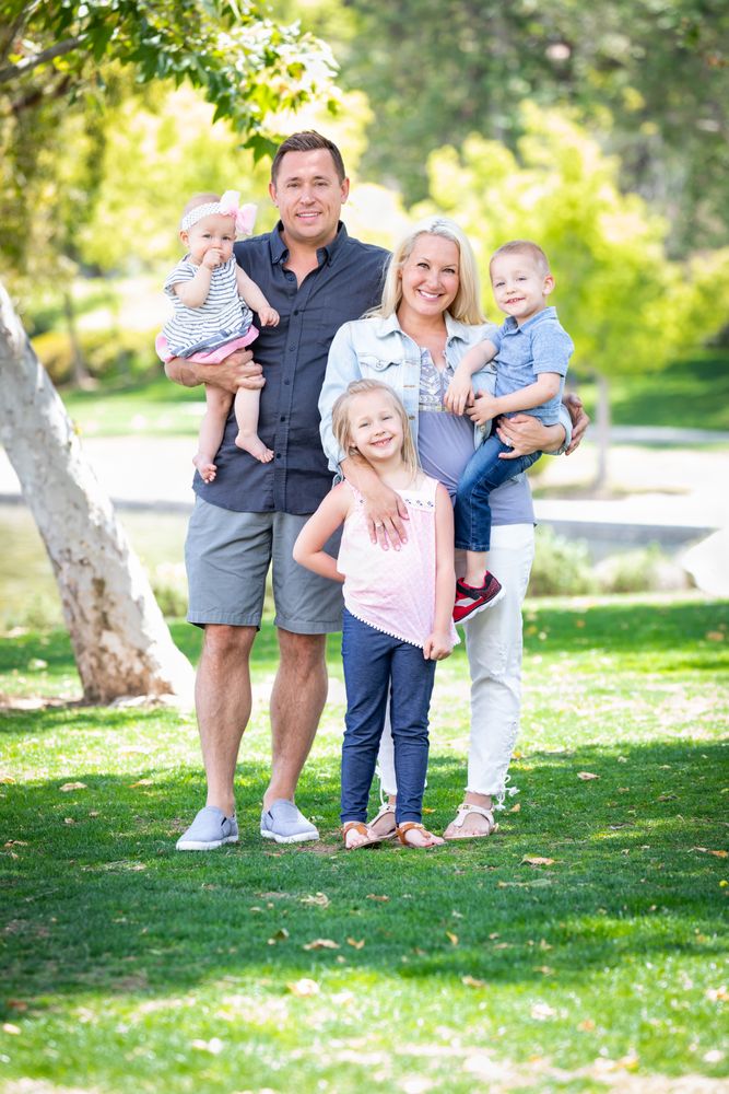 Happy Young Family Portrait In The Park