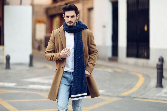 Man walking in smart winter jacket and scarf in the street