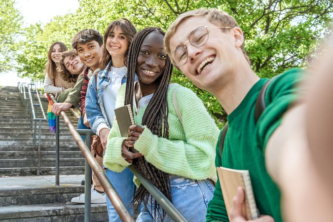 Diverse group of students gather on the university campus stairs