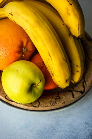 Bowl of fruit with oranges, apple and bananas