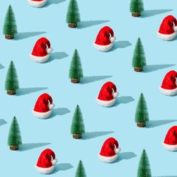 Christmas pattern made with Christmas tree and Santa Claus hat