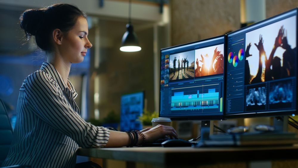 Female Video Editor Works with Footage and Sound on Her Personal Computer.