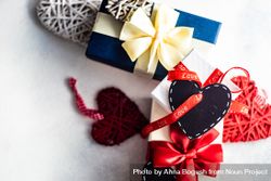 Multiple giftboxes wrapped in red ribbon with heart tag bxAAvv