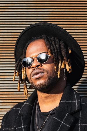 Stylish Black man with dreadlocks on street