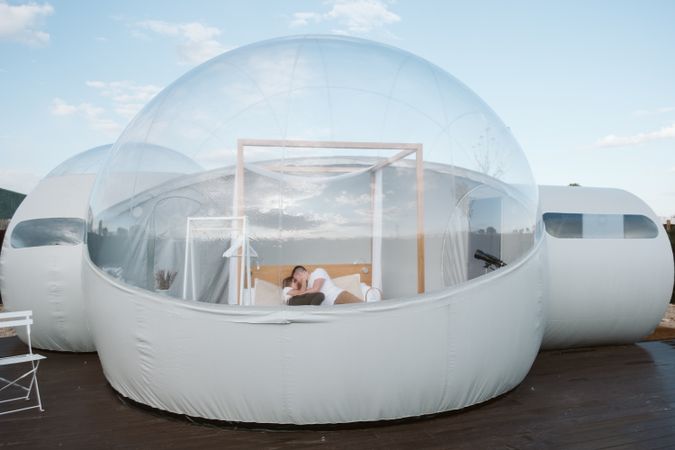 Passionate couple on bed in bubble hotel