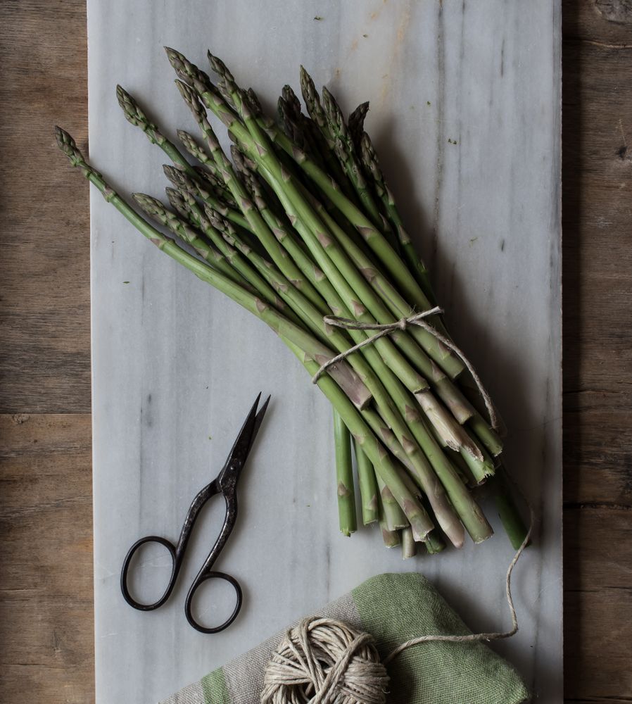Arrangement of twine and asparagus on board