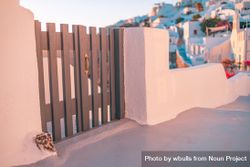 Wooden gate with Santorini in background at sunset 0yV2O5