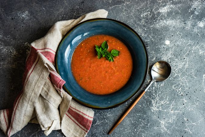 Top view of tomato cream soup with herbs