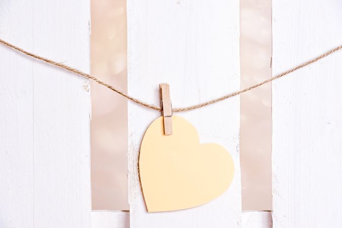 Yellow heart with wooden clip on string