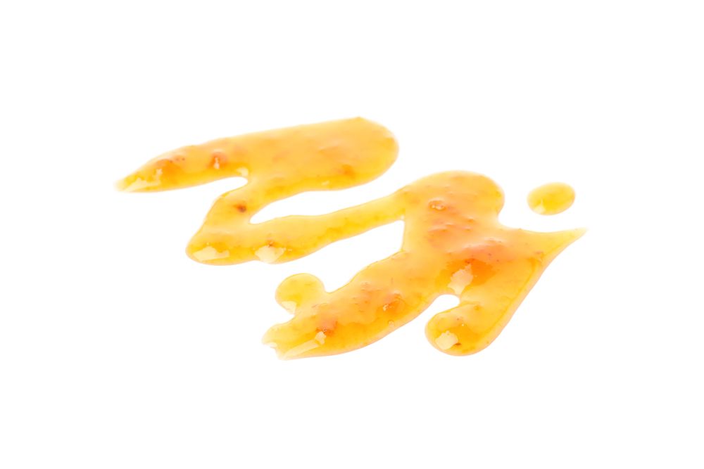 Delicious apricot jam isolated on plain background