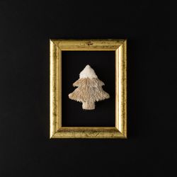 Gold frame with festive tree on dark background