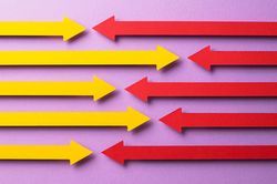 Yellow and pink paper arrows facing each other